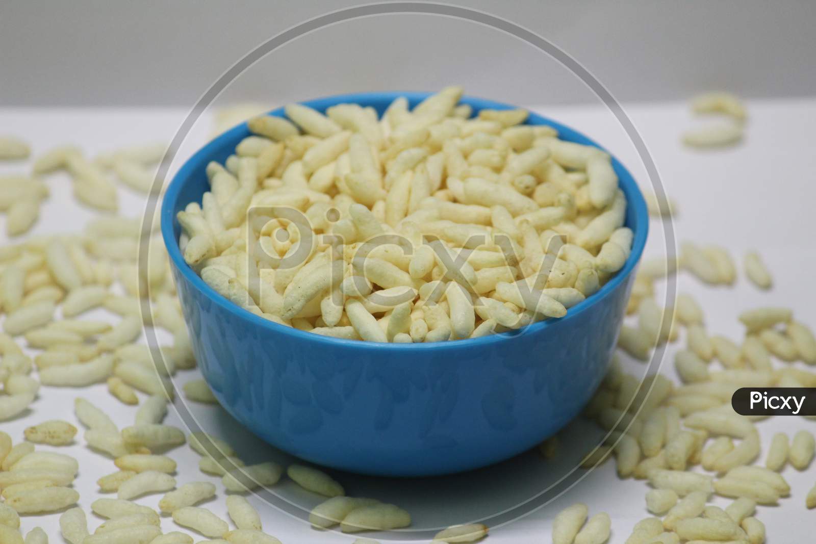 Puffed Rice On The Blue Bowl With White Background