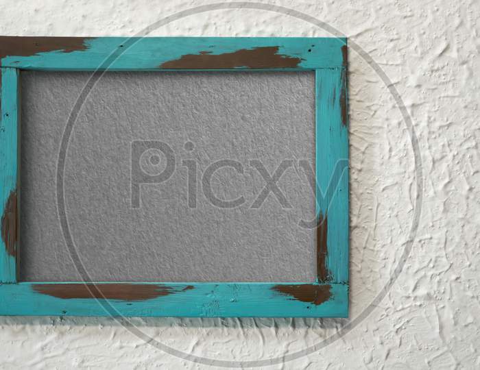 A grungy wooden frame with textured with concrete background and copy space
