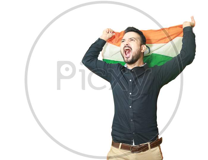 Cheerful Handsome Young Indian Man Waving Indian Flag Screams With Excitement, Celebrating Republic Day Or Independence Day, Isolated On White Background Copy Space To Write Text.