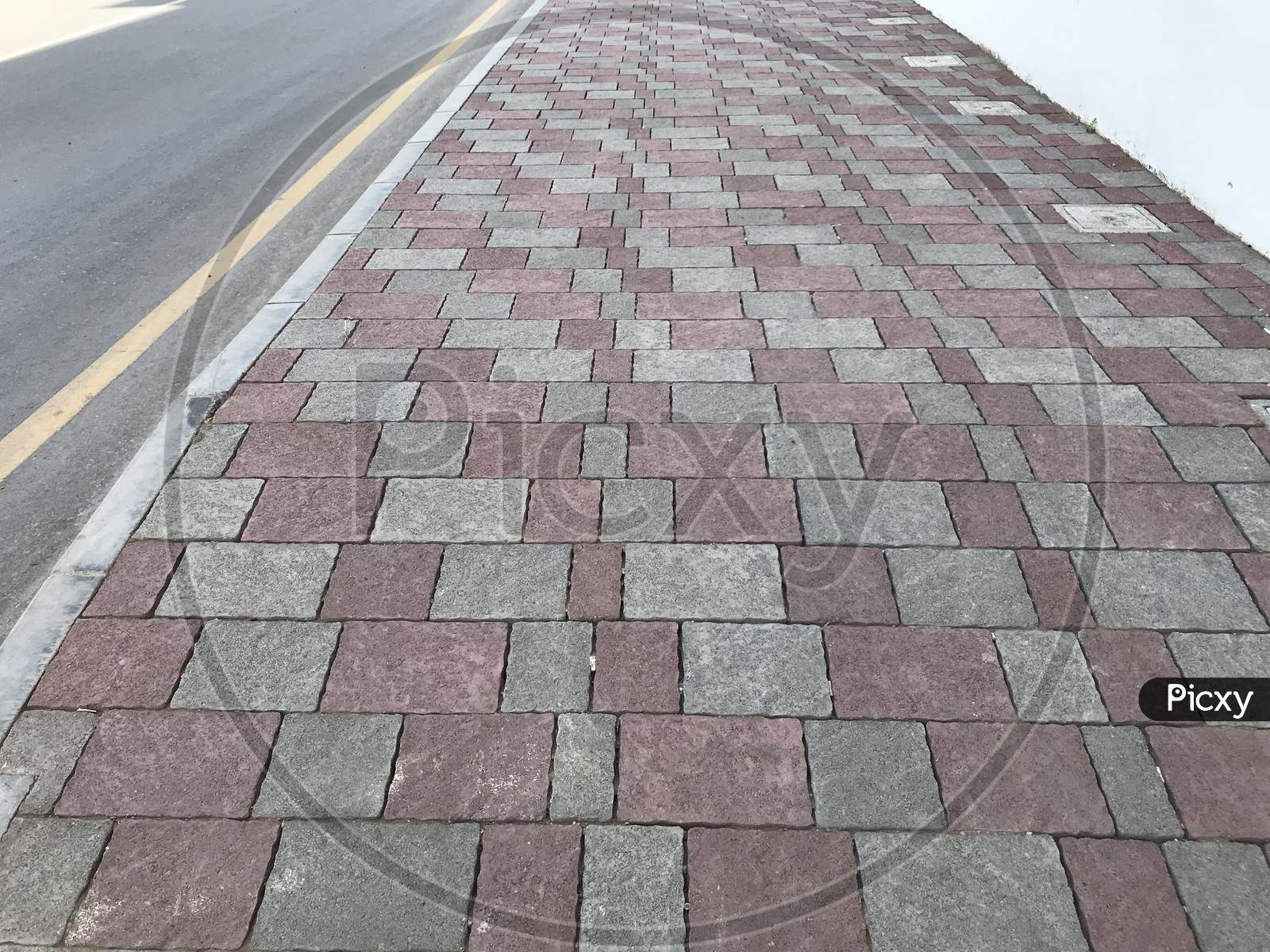 Interlock Tile Flooring And Protected By Kerb Precast Concrete Stones Before The Highways Or Roadways Infrastructure