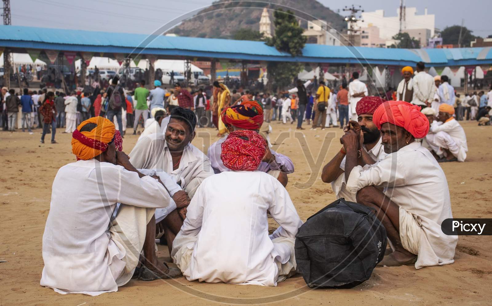 11 December 2019 Pushkar Rajesthan, India Man Sitting On Ground During Pushkar Fair In Pushkar Fair Ground.