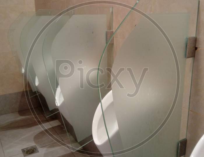 Urinals And Glass Partition With Frosted Film For Privacy Purpose In Men Toilet Or Lavatory And Partitions Fixed With Wall By Using Stainless Steel Clip Screwed