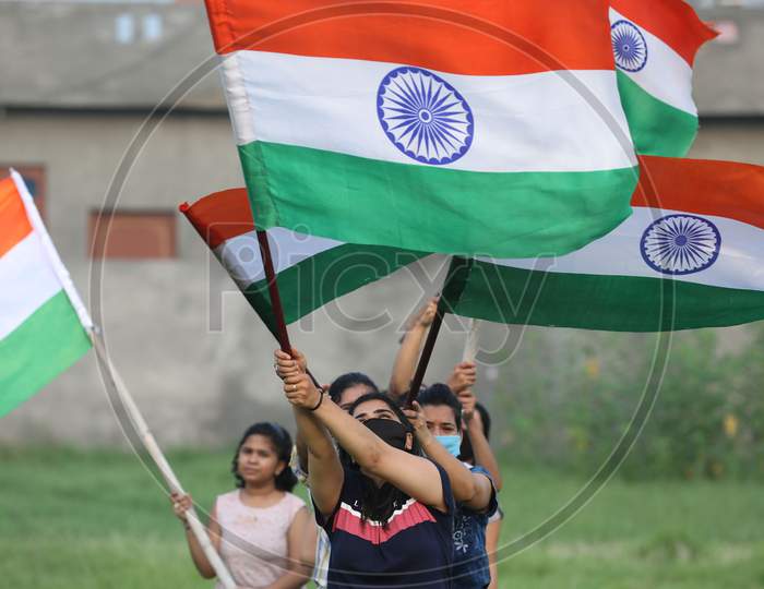 Girls hold the tricolor during rehearsals ahead of Independence Day at Jammu on August 10 ,2020.