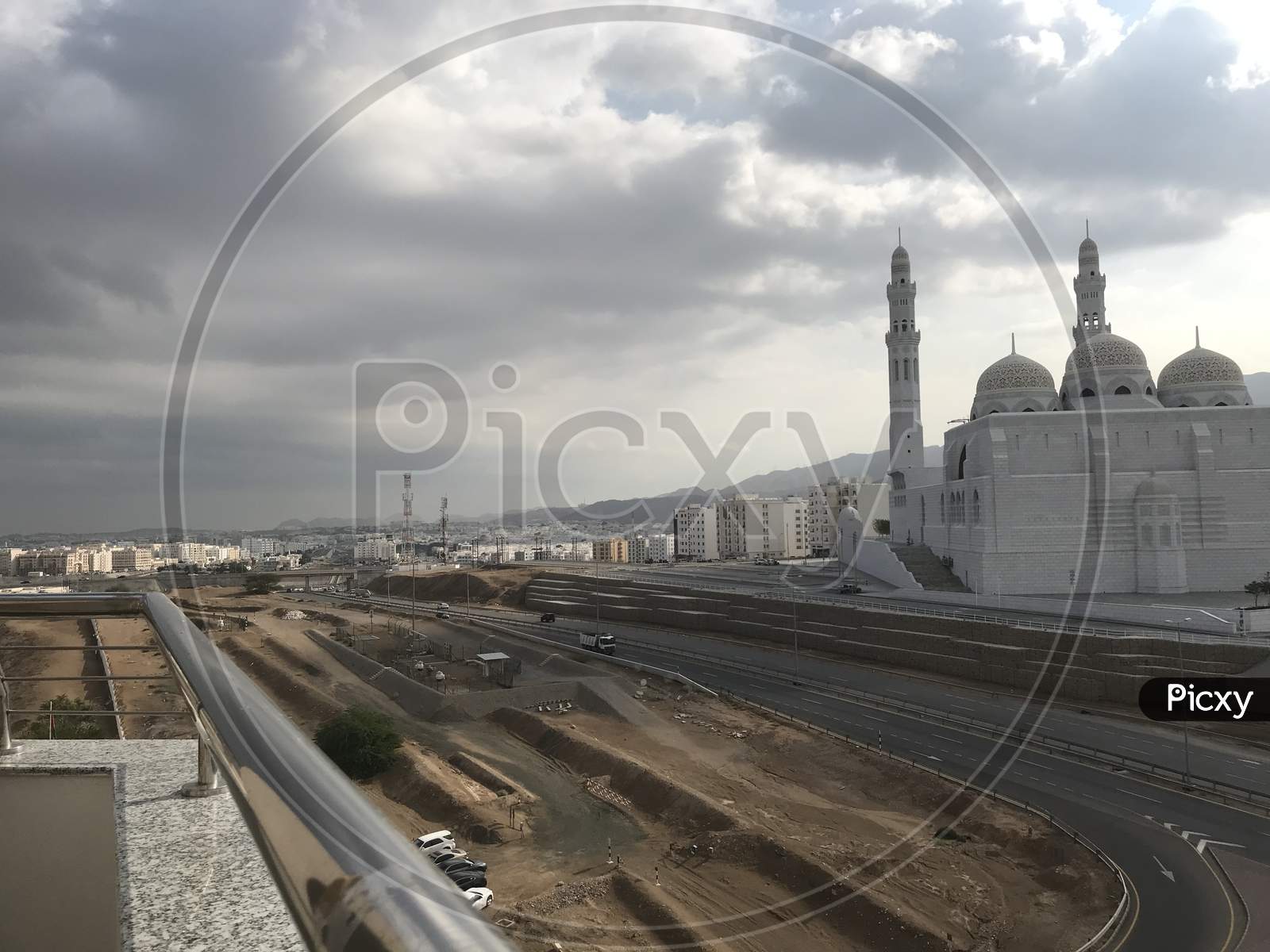 Al Islamic Mosque Picture With The Background Of Muscat City With Cloudy Sky And Such A Beautiful View Of Cityscape