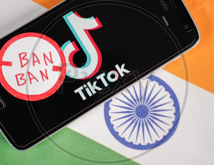 Maski, India - 4 August, 2020 : Tiktok Logo On Phone And Ban Stamp With Indian Flag As Background.