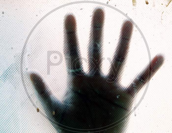A Girl Hand Behind The Blur Glass