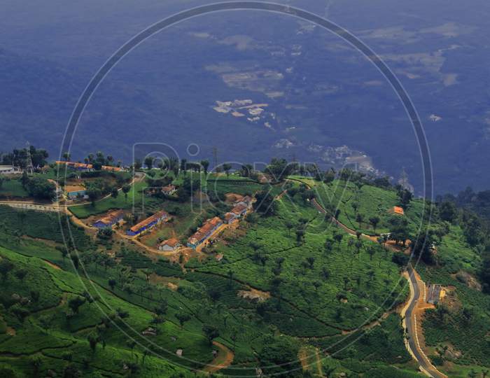 birds eye view of coonoor tea garden and nilgiri foothills from a hill top at coonoor, near ooty hill station in tamilnadu, south india