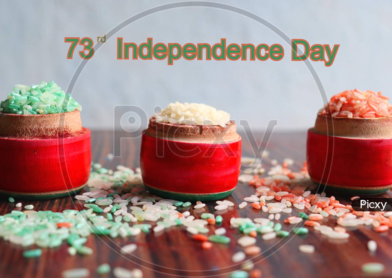 Indian 73rd independence day written with tri coloured rice in wooden lakka pidatha