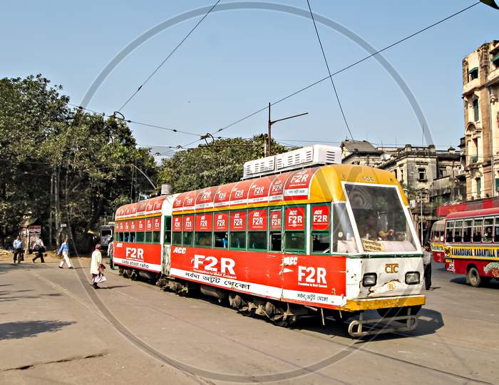 Kolkata, West Bengal, India-February 6Th,2012: Colorful Tram Exits Its Depot To Travel Through Busy,Crowded Streets Of Kolkata.