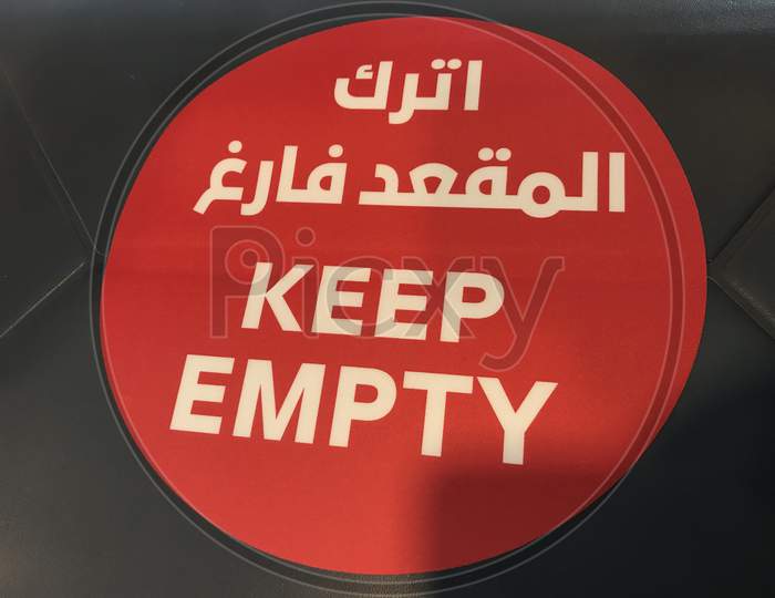 Keep Empty Letters Written In White Fonts Over Red Background In Chairs To Maintain Social Distancing In Public Office