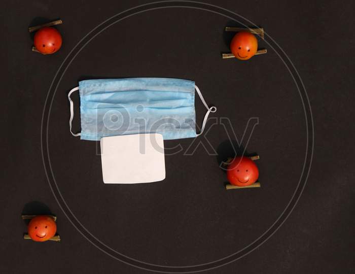 Social Distancing or Safe Distance Conceptual Photo with Medical Face Mask and Tomato Made Characters