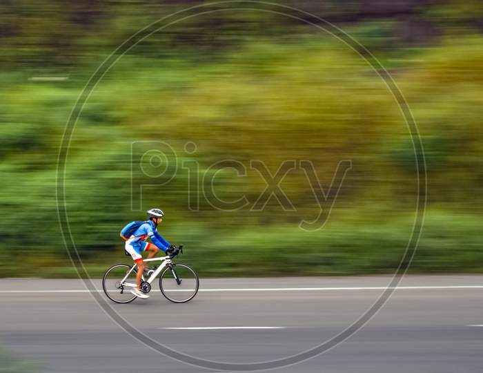 Pune, Maharashtra, India - October 1St, 2017 : Motion Blur, Panning Image Of A Bicycle Rider Wearing Helmet For Safety On A Way Fo