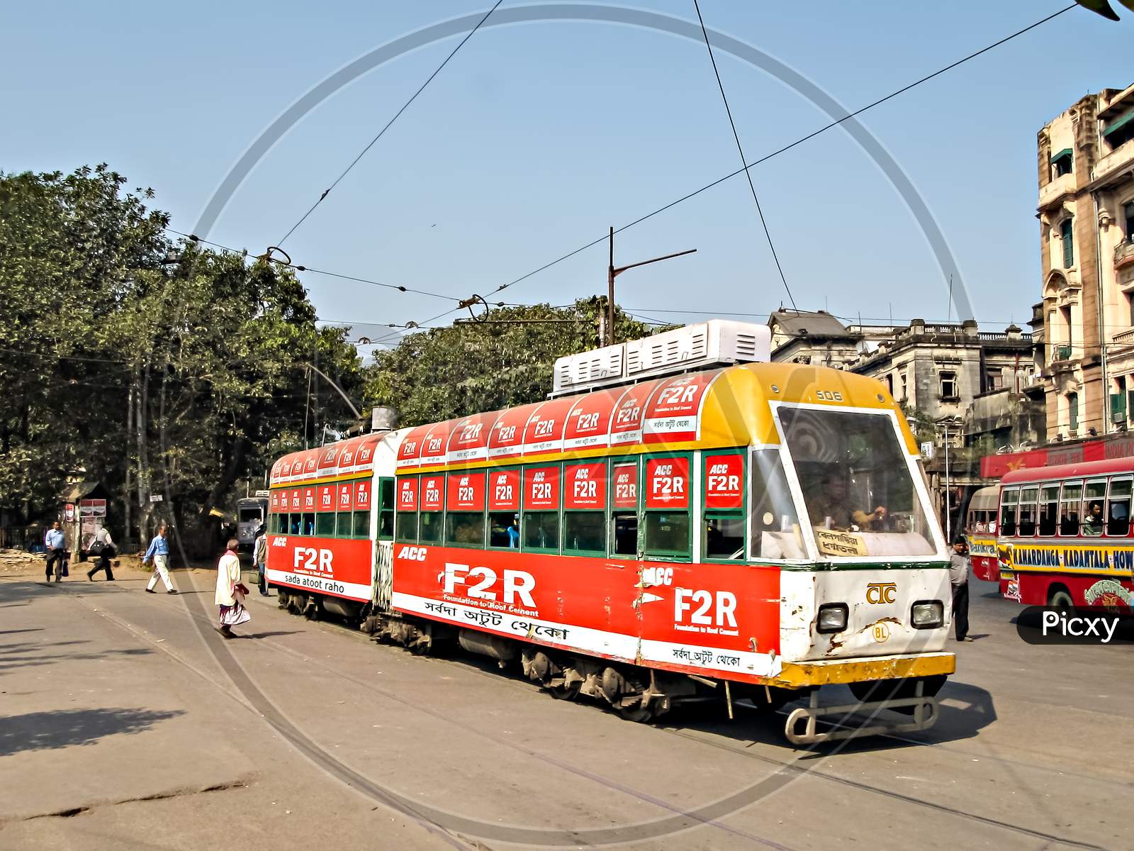 Kolkata, West Bengal, India-February 6Th,2012: Colorful Tram Exits Its Depot To Travel Through Busy,Crowded Streets Of Kolkata.