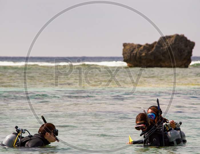 People Scuba Diving In Okinawa Island, Japan