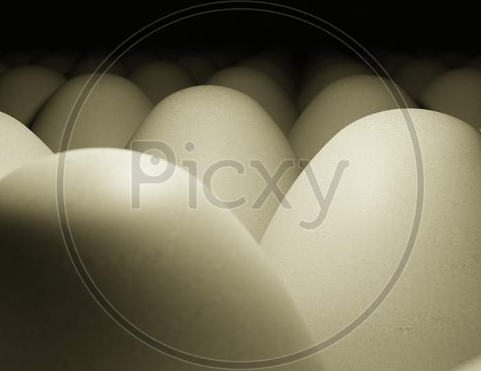 Close Up View Of Raw Chicken Eggs With A Dark Background