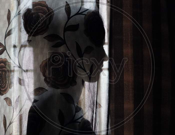 Shadow Of A Girl Who Is Behind The Curtain