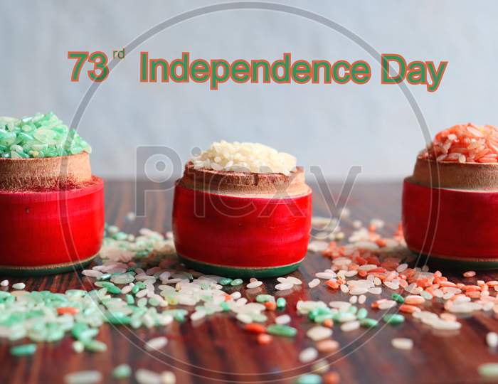 Indian 73rd independence day written with tri coloured rice in wooden lakka pidatha