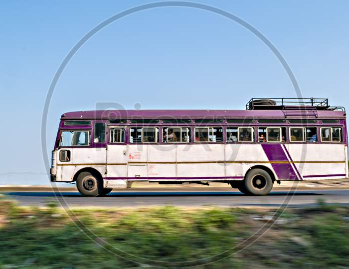 Isolated , Slow Shutter Speed Panning Image Of A Speeding State Transport Bus On Highway In Maharashtra, India.