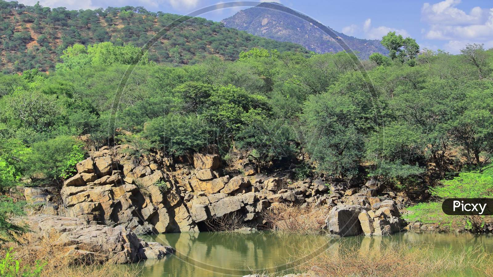 rocky landscape and chinnar river (a small tributary of kaveri river) at hogenakkal in tamilnadu, india