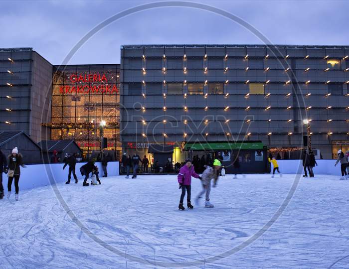 Krakow, Poland - November 30, 2014: Children Enjoying Ice Skating Before Galeria Krakowska In City Center