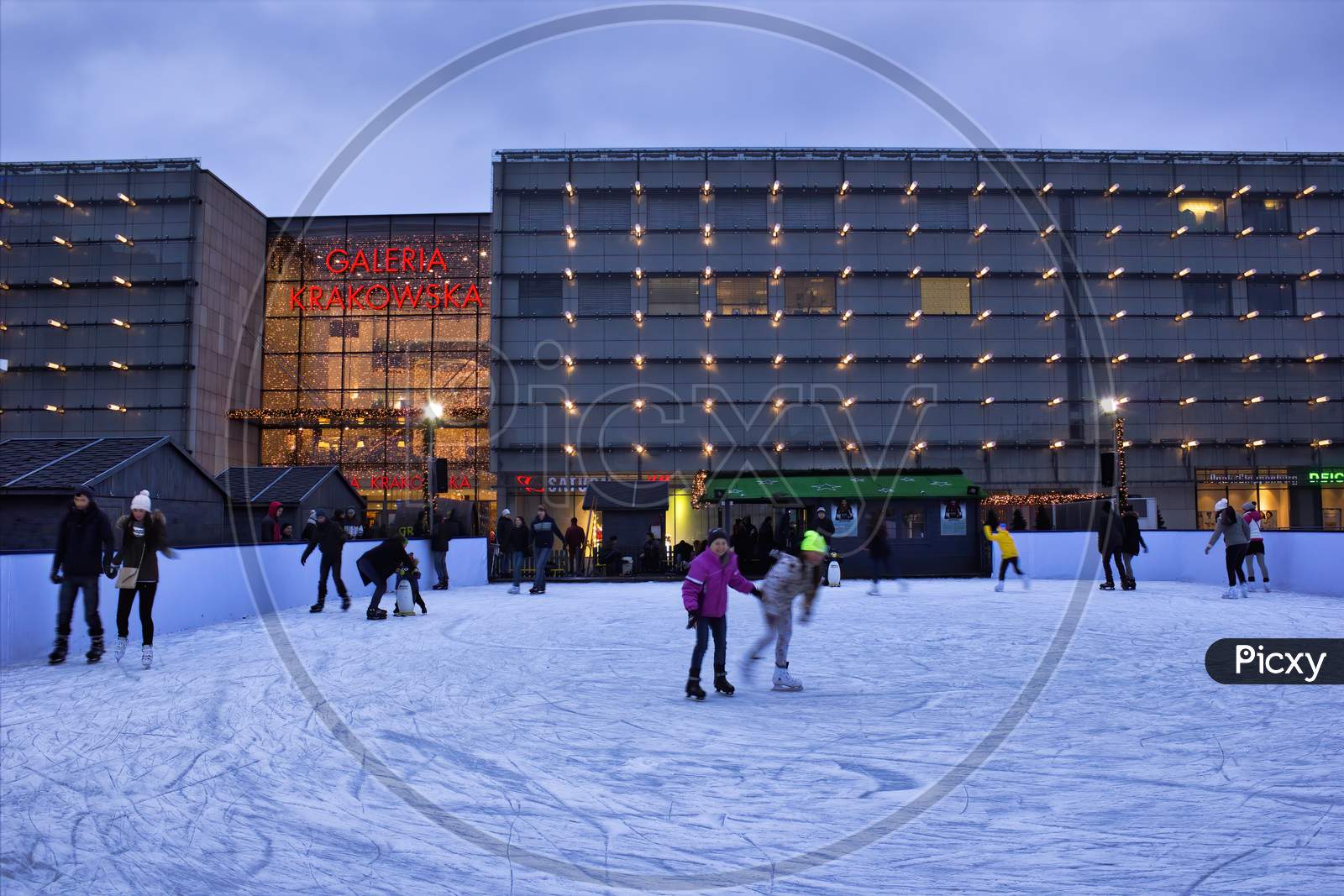 Krakow, Poland - November 30, 2014: Children Enjoying Ice Skating Before Galeria Krakowska In City Center