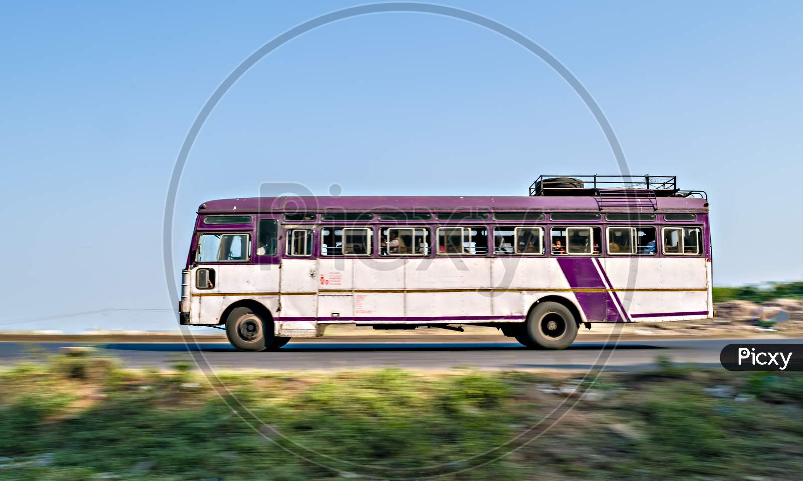 Isolated , Slow Shutter Speed Panning Image Of A Speeding State Transport Bus On Highway In Maharashtra, India.