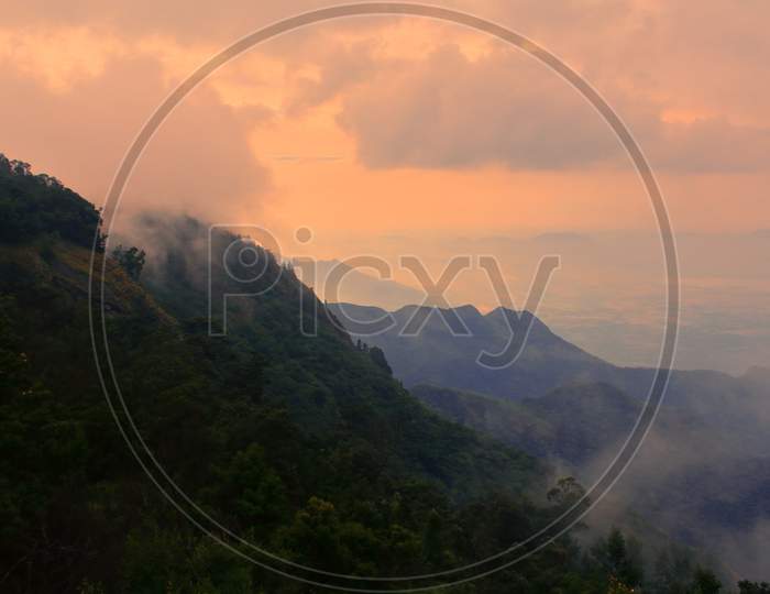 scenic view of colorful cloudy sky and tropical rain forest, on the slope of palani hills at kodaikanal, tamilnadu in india