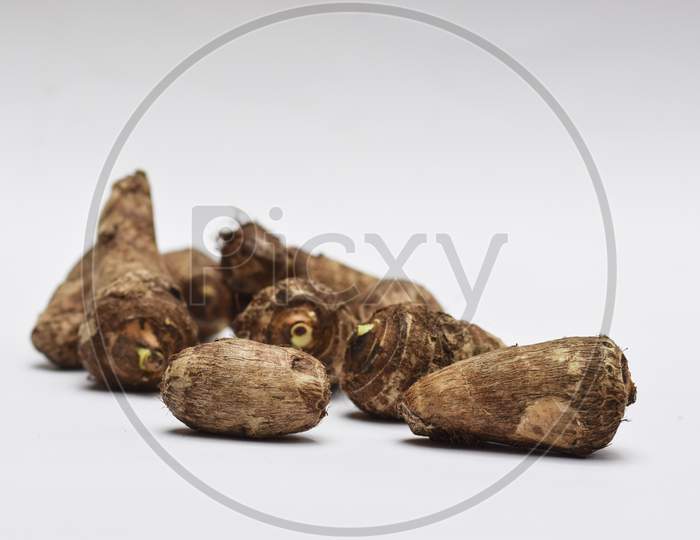 Whole Taro Root Or Colocasia Esculenta Raw Root Vegetable Also Known As Arbi In India On White Background
