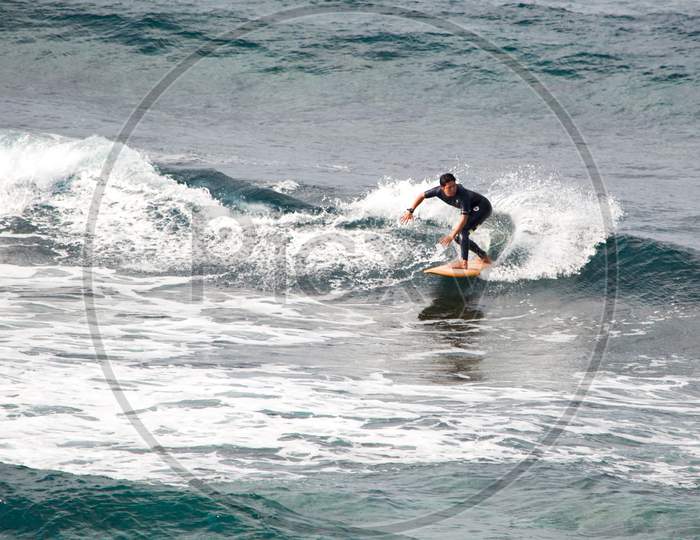 Surfer Riding The Waves In Okinawa Island Of Japan