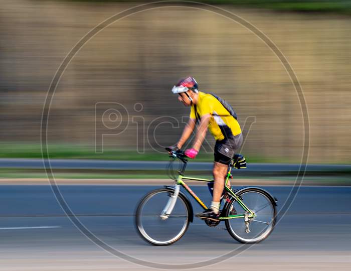 Pune, Maharashtra, India - October 4Th, 2017 : Motion Blur, Panning Image Of A Bicycle Rider Wearing Helmet For Safety On A Way .