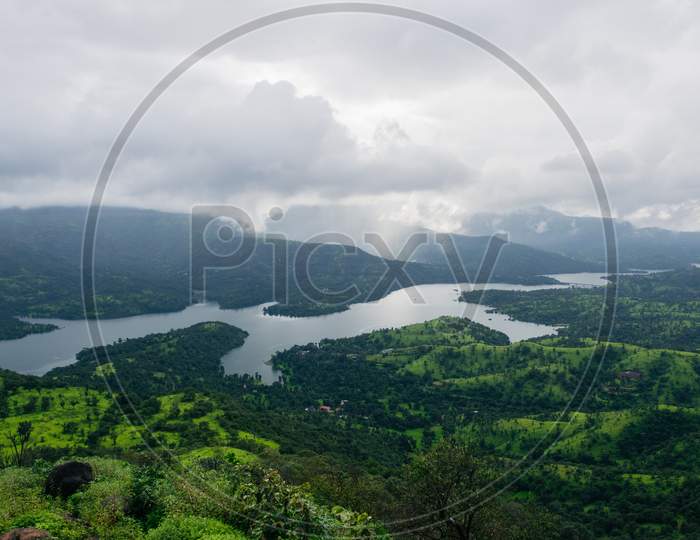 Panoramic View Of Koyna River From The Top Of A Lush Green Mountain In Tapola, Maharashtra, India