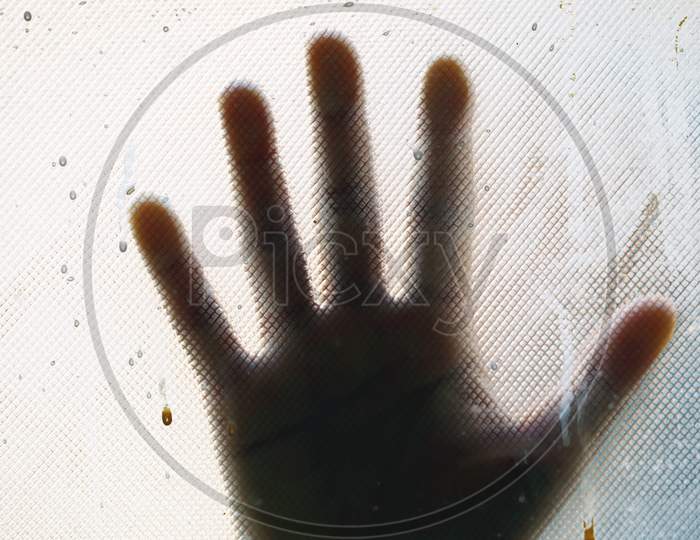 A Girl Hand Behind The Blur Glass