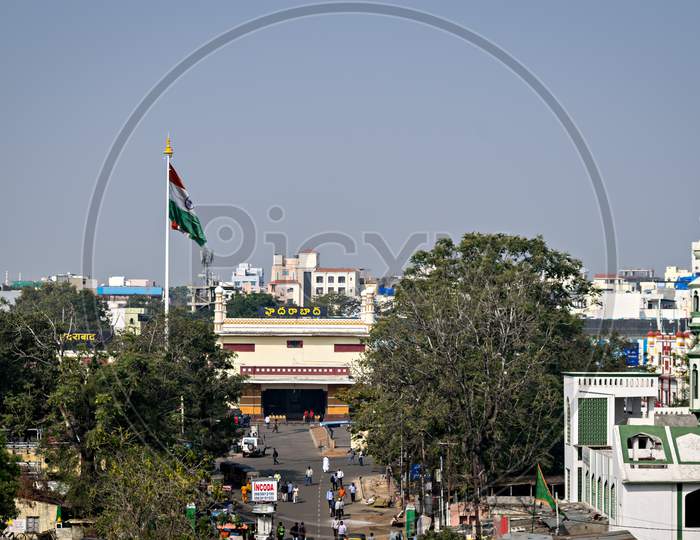 View Of Hyderabad Station With Indian Flag And Blue Sky And Vehicles Traffic..