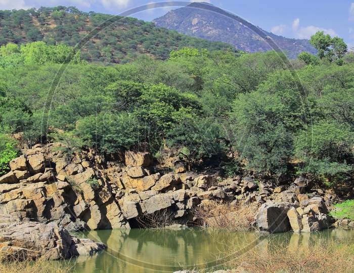 rocky landscape and chinnar river (a small tributary of kaveri river) at hogenakkal in tamilnadu, india