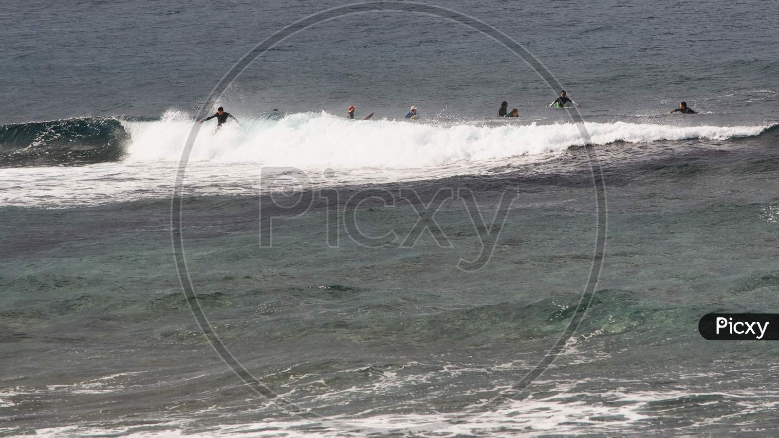 Large Group Of Surfers Riding The Waves In Okinawa Island Of Japan
