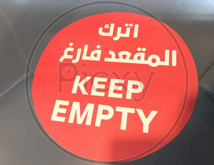 Keep Empty Letters Written In White Fonts Over Red Background In Chairs To Maintain Social Distancing In Public Office
