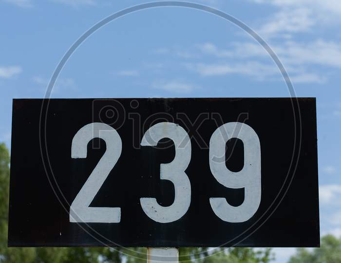 A Low Angle Shot Of A Signpost With 239 Number On It