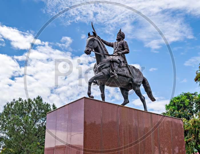 Jammu,India-April18Th,2019:Beautifully Sculptured Horse Riding Statue Of Maharaja Gulab Singh(1792-1858)- The Founder Of Jammu & Kashmir State With Nice Blue Clouds In Background Sky.