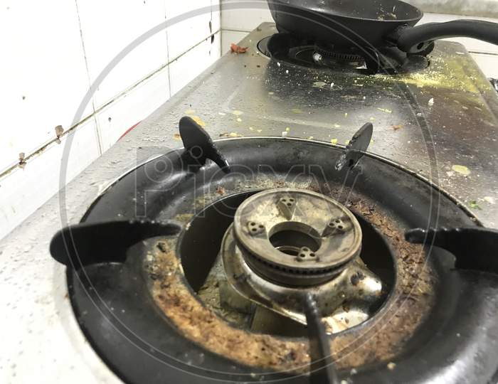 Uncleaned And Food Waste Scattered Over The Surface Of The Stainless Steel Finished Gas Stoves
