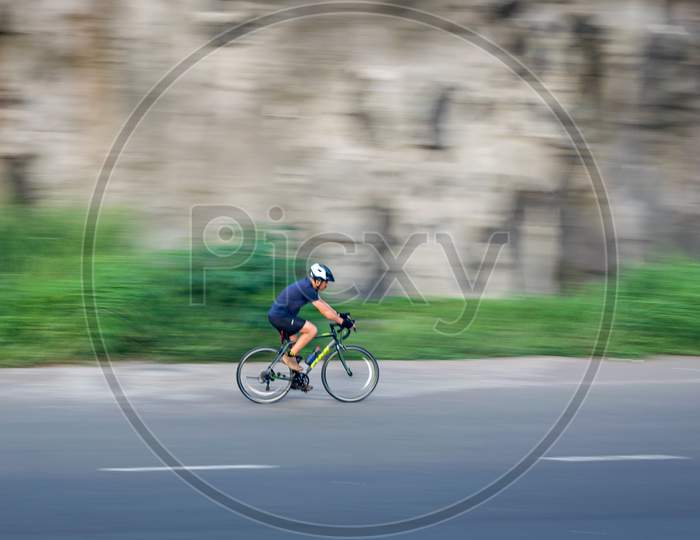 Pune, Maharashtra, India - October 4Th, 2017 : Motion Blur, Panning Image Of A Bicycle Rider Wearing Helmet For Safety .