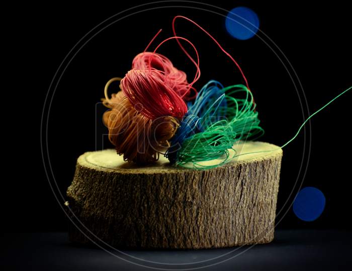 A Closeup Image Of Multicolored Threads .