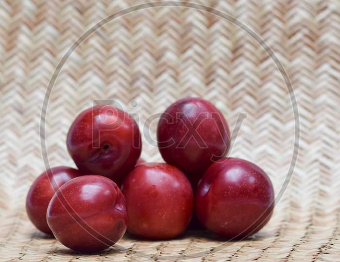 Single Plum Isolated On White Background. Close Up Of Fruit. Purple Red Maroon Cherry Plum