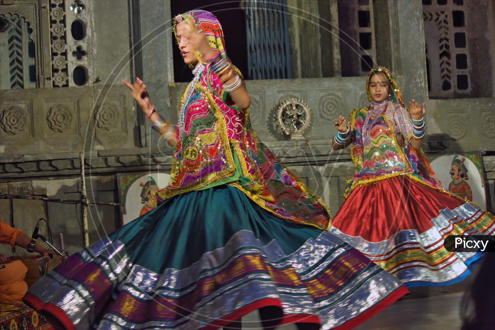 Udaipur, India - May 24, 2013: Two Indian Women Dancing In Rajasthan State Of India In Traditional Colorful Dress