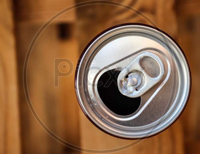 Close Up Top View Up A Can Of Soft Drink Isolated On Wooden Background