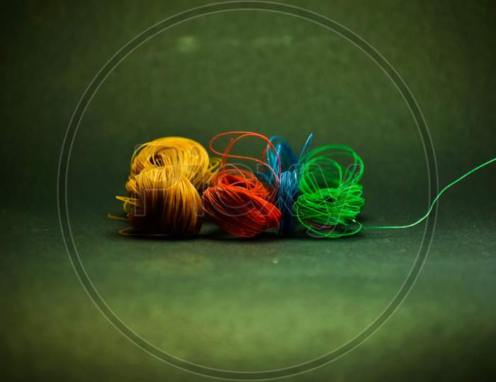 A Closeup Image Of Multicolored Threads .