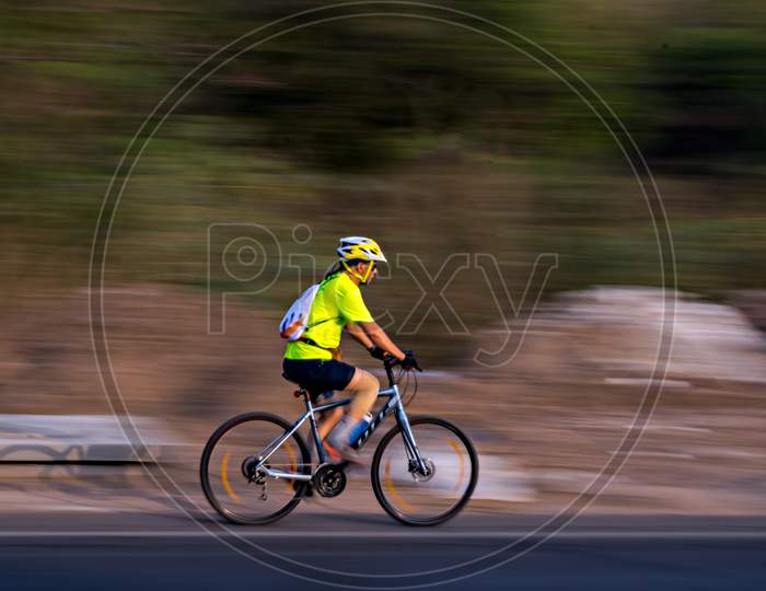 Pune, Maharashtra, India - October 4Th, 2017 : Motion Blur, Panning Image Of A Bicycle Rider Wearing Helmet For Safety.