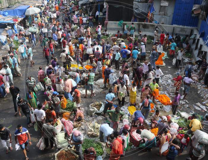 People throng the Mullik Ghat Flower Market flower market as they flout the social distancing norms in Kolkata, August 12, 2020.