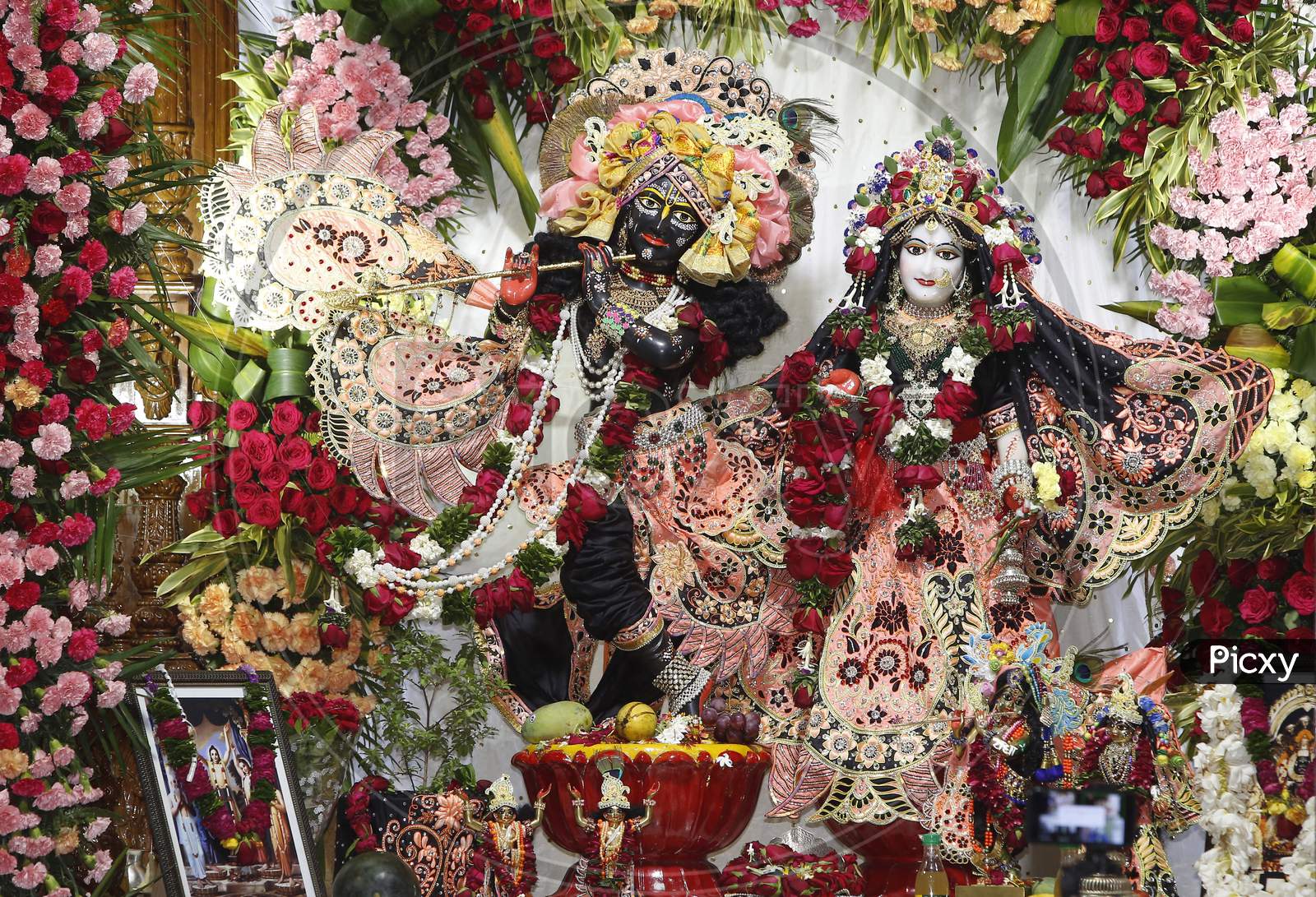 Decorated idols of Hindu Lord Krishna and his Consort Radha are seen in a picture during Janmashtami celebrations at ISKCON  (The International Society for Krishna Consciousness) temple in Chandigarh August 12, 2020