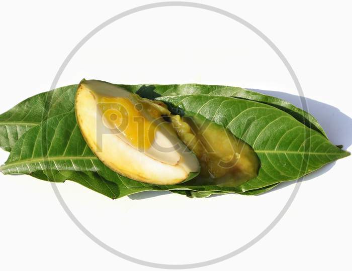 Mango Chutney With Raw Mango Cut On Leaves Isolated On White Background
