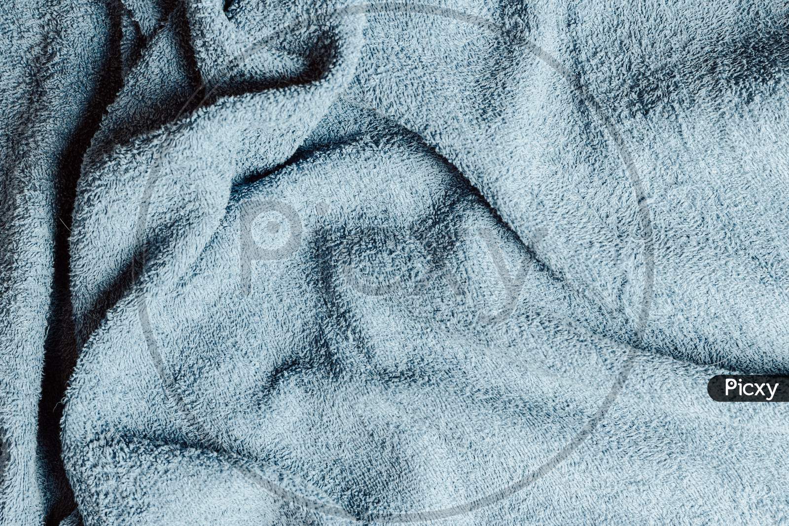 Top View From The Top Of A Light Blue Towel With Some Hard Wrinkles